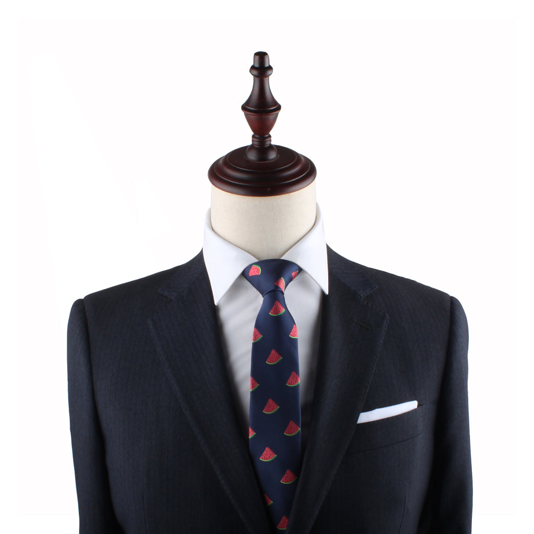 A mannequin dressed in a dark suit, white dress shirt, and a Watermelon Slim Tie exudes timeless style and freshness.