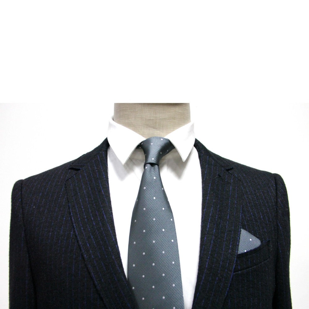 Mannequin dressed in a monochrome ensemble, showcasing a pinstripe suit paired with a white shirt and the enchantingly stylish Grey White Polka Dot Business Tie from the tie and pocket square set.