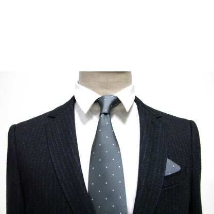 Mannequin dressed in a monochrome ensemble, showcasing a pinstripe suit paired with a white shirt and the enchantingly stylish Grey White Polka Dot Business Tie from the tie and pocket square set.