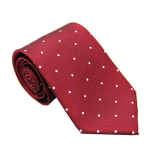 A White Polka Dot Red Skinny Tie, exuding a festive flair, rolled up against a white background.