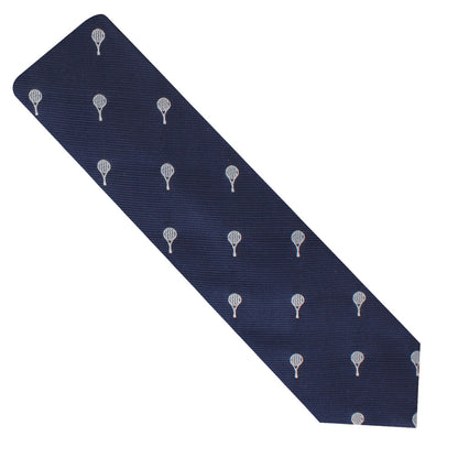 A Tennis Skinny Tie in navy blue featuring a timeless repeating pattern of small white hot air balloons.