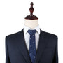 A mannequin dressed in a dark pinstripe suit with a white dress shirt and a navy blue Wolf Skinny Tie exuding strength and elegance.