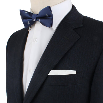 Wearing a dark pinstripe suit, an individual complemented their look with the Wolf Bow Tie, featuring small sailboat patterns, perfectly paired with a white dress shirt and pocket square.