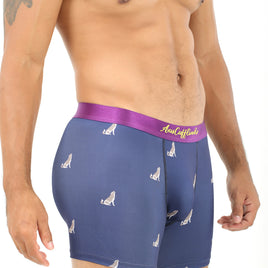 A man models navy "Wolf Underwear" boxer briefs with a purple waistband and a white wolf print, providing a breathable fit.