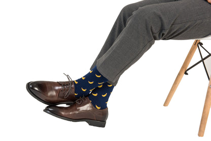 A person's legs with a pair of Banana Socks and shoes.