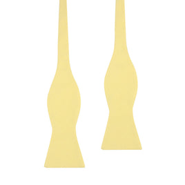 Two yellow bow-shaped pasta pieces stand out against a white background, resembling the chic appeal of a Yellow Self Tie Bow Tie for the modern gentleman.