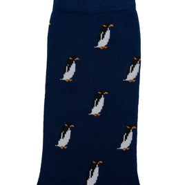 A pair of Penguin Socks, dark blue with a pattern of penguins scattered across its surface, offering a touch of arctic allure and cozy comfort.