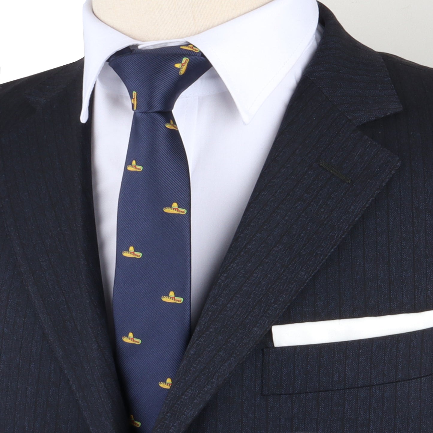 Close-up of a person in a dark pinstripe suit, white dress shirt, and the mexican theme tie featuring a navy blue background adorned with playful yellow duck patterns, exuding dapper design. The white pocket square adds a touch of flair to the ensemble's fiesta vibes.